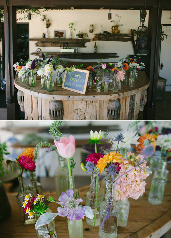 rustic bottle vases filled with colorful flowers