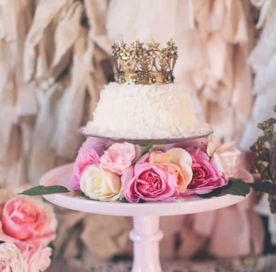 gold crown-topped, white frosted cake with rose accents