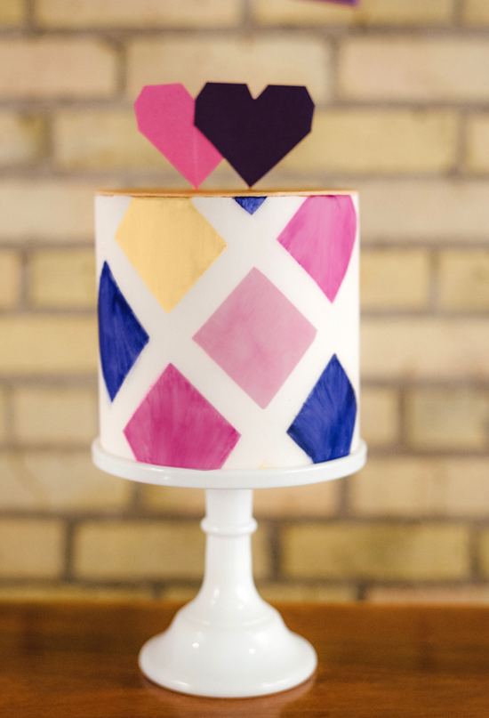 geometric painted cake and heart cake toppers