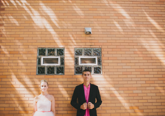 pale pink chiffon wedding dress and bright pink groom's shirt
