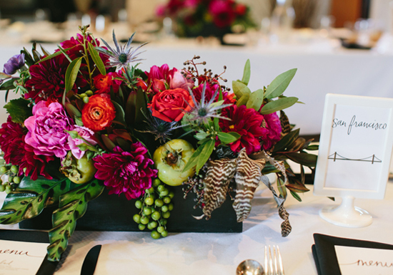 colorful floral centerpieces and framed table labels | Photo by Jessica Burke