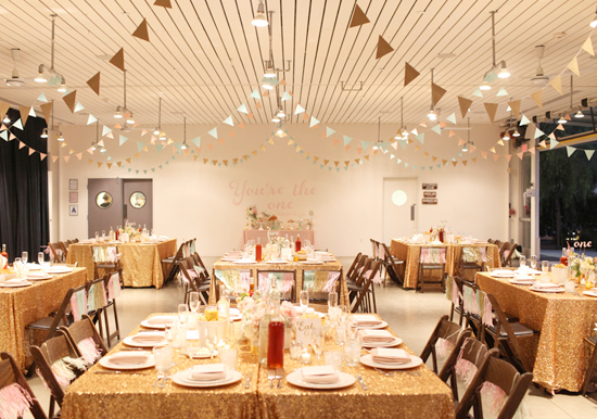 paper bunting garlands and gold sparkle linens | Photo by Kimberly Genevieve