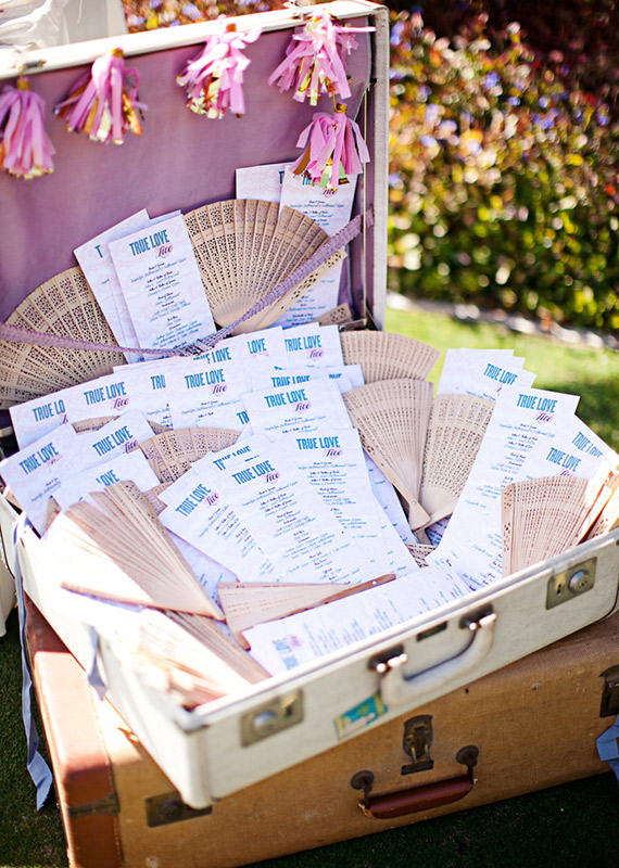 Wedding programs displayed in suitcase | photos by Meg Perotti | Planning Sitting in a Tree |100 Layer Cake