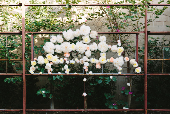 Paper flower ceremony backdrop | Photo by Mary Costa Photography | Read more - http://www.100layercake.com/blog/wp-content/uploads/2015/04/DIY-Elysian-Los-Angeles-Wedding