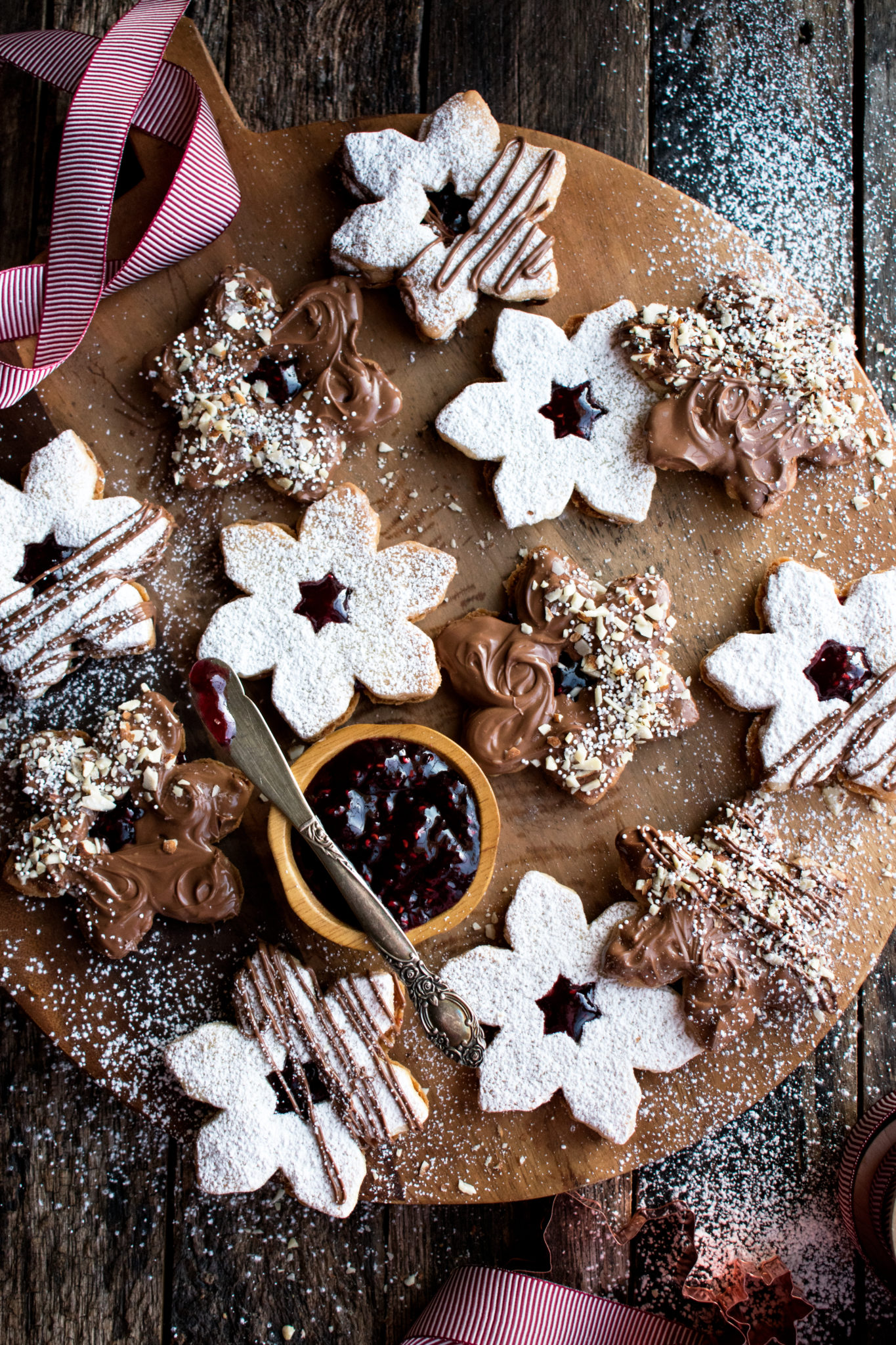 Chocolate dipped shortbread cookie sandwiches with raspberry jam