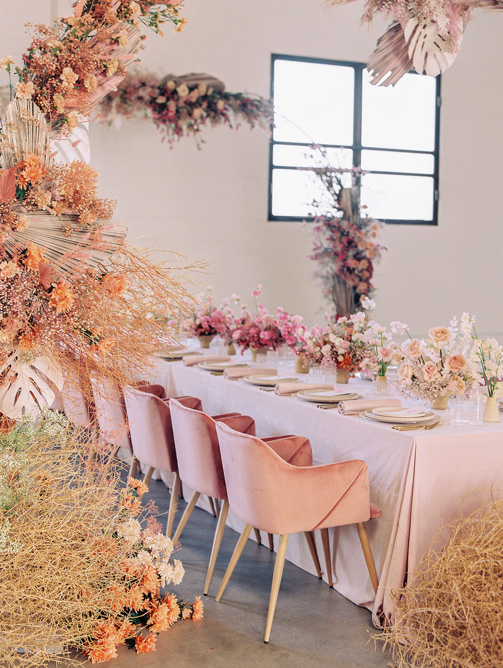 modern pink tablescape with dried floral arch
