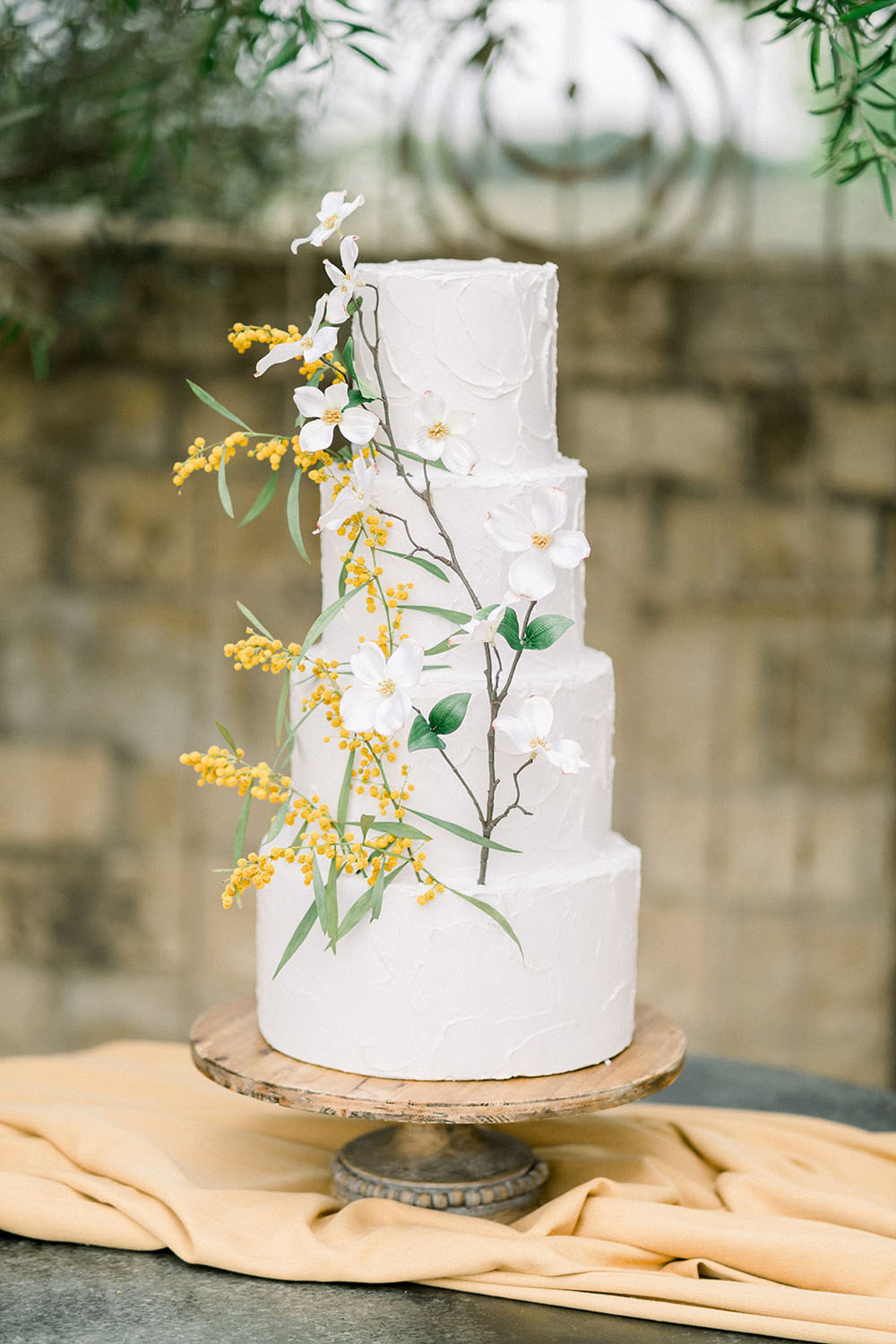 white and yellow floral wedding cake