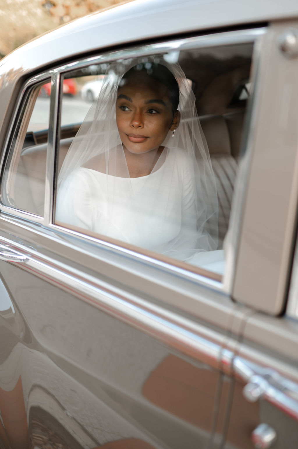 Elegant bride portrait in vintage car