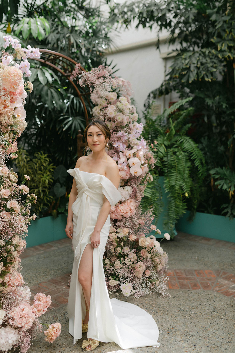 bow wedding dress and floral ceremony arch at Valentine DTLA wedding