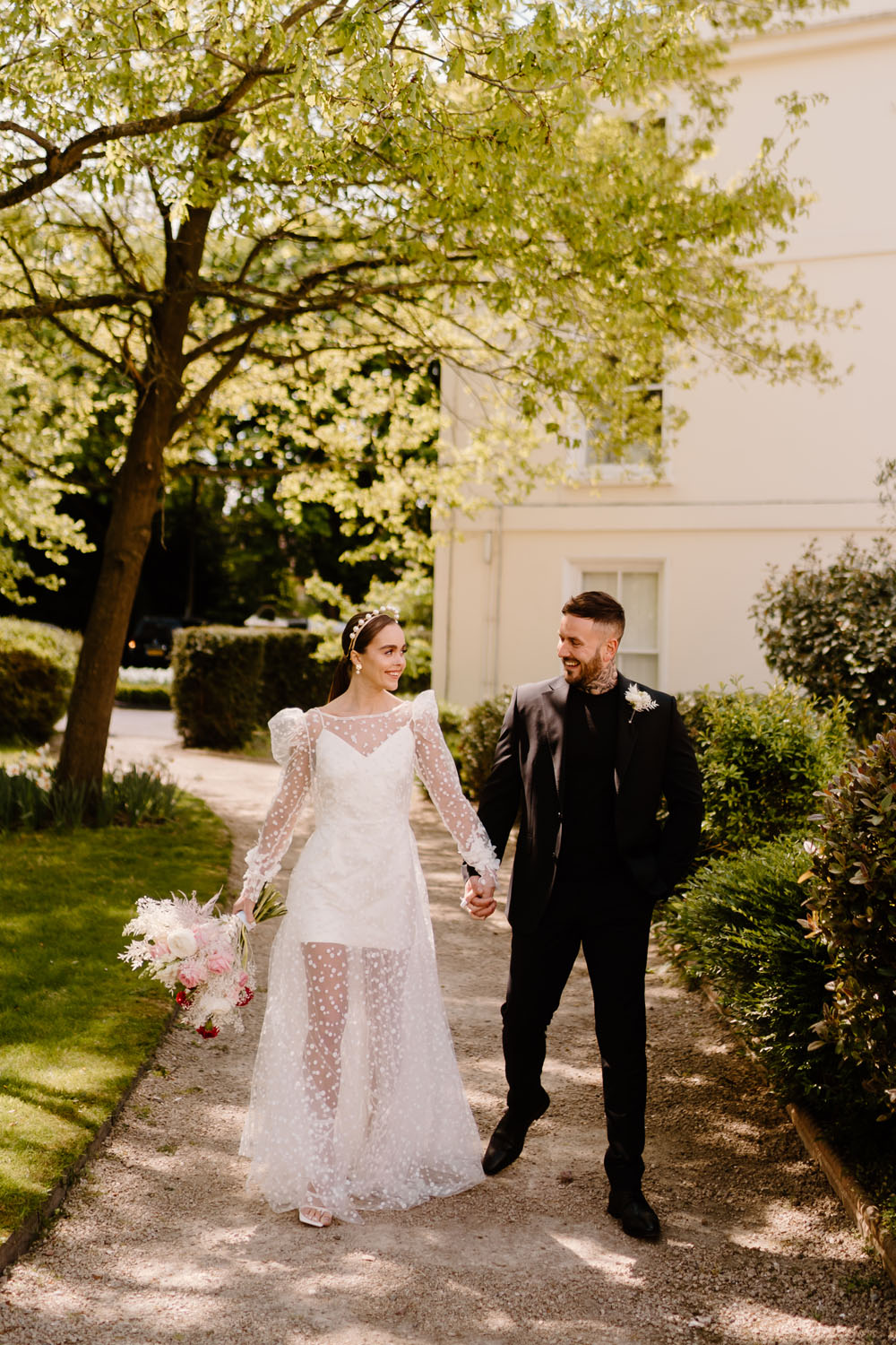 portrait of groom and bride with polka dot wedding dress