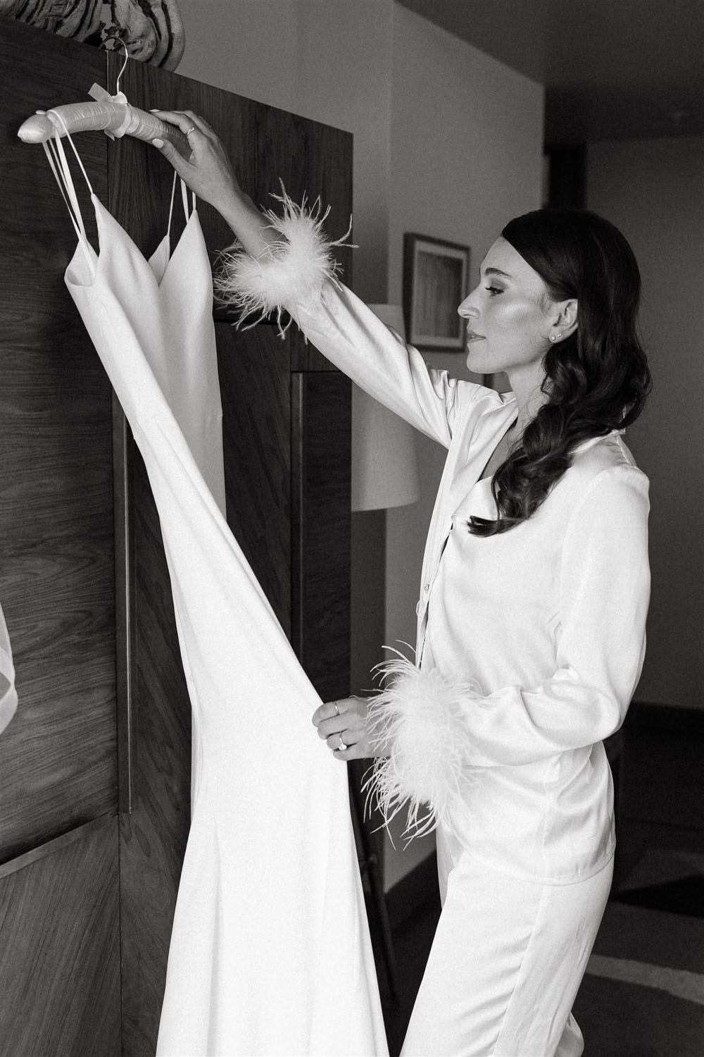 bride getting ready in feather pjs