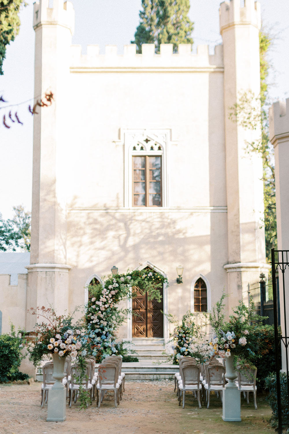 Spring floral ceremony arch at Greek castle wedding