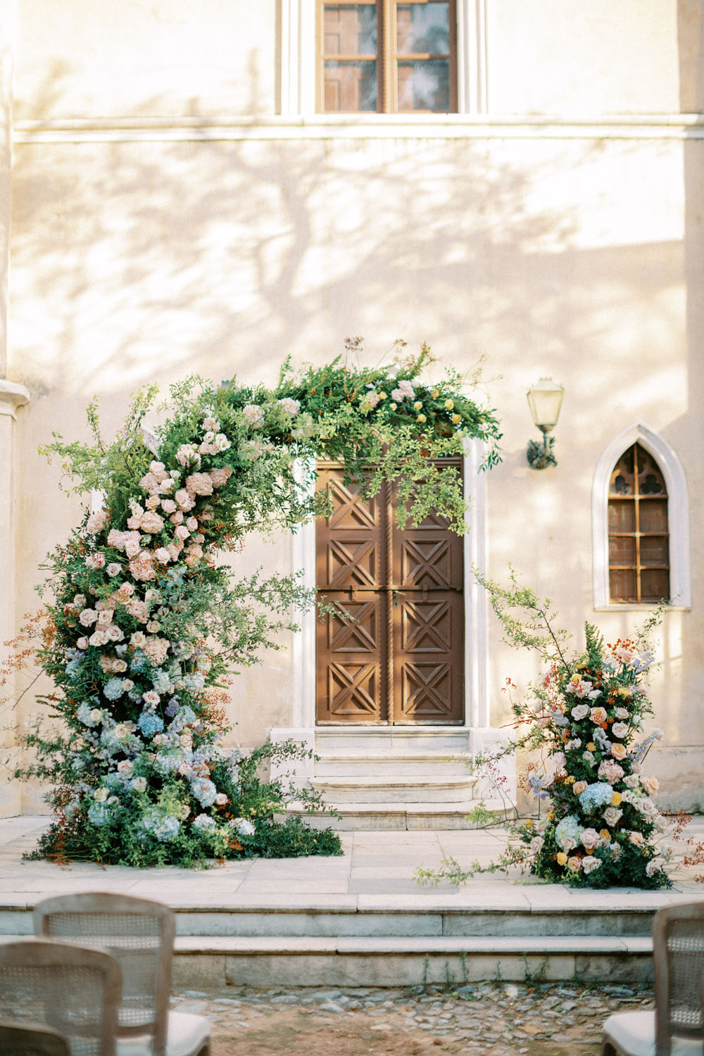 Spring floral ceremony arch at Greek castle wedding