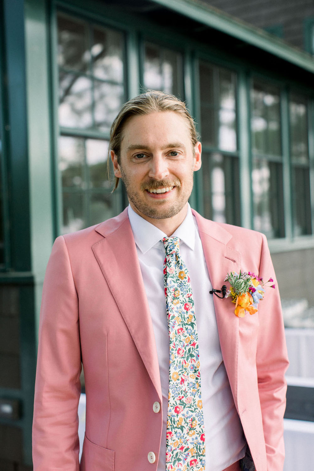 pink groom's suit and floral tie for diy summer wedding