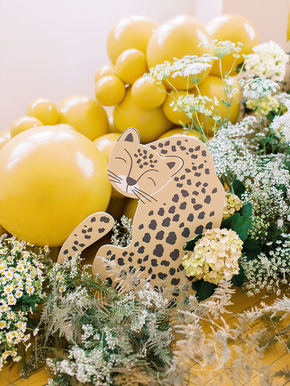 Leopard and balloon decorations for Yellow floral first birthday and Korean Dol