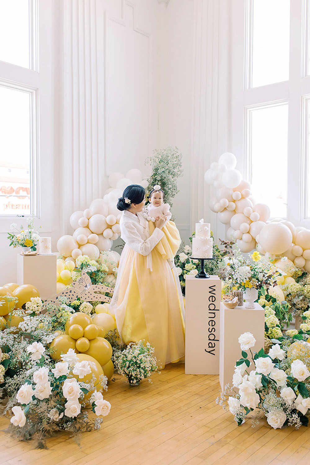Yellow floral first birthday and Korean Dol with balloon decorations