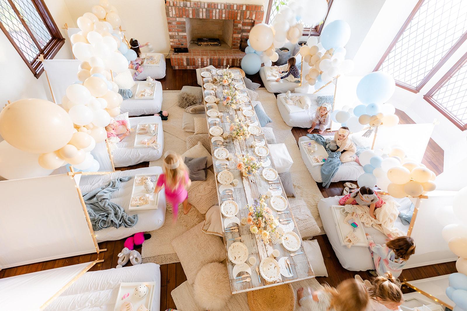 low table with blue and white balloon decorations for girls sleepover birthday party