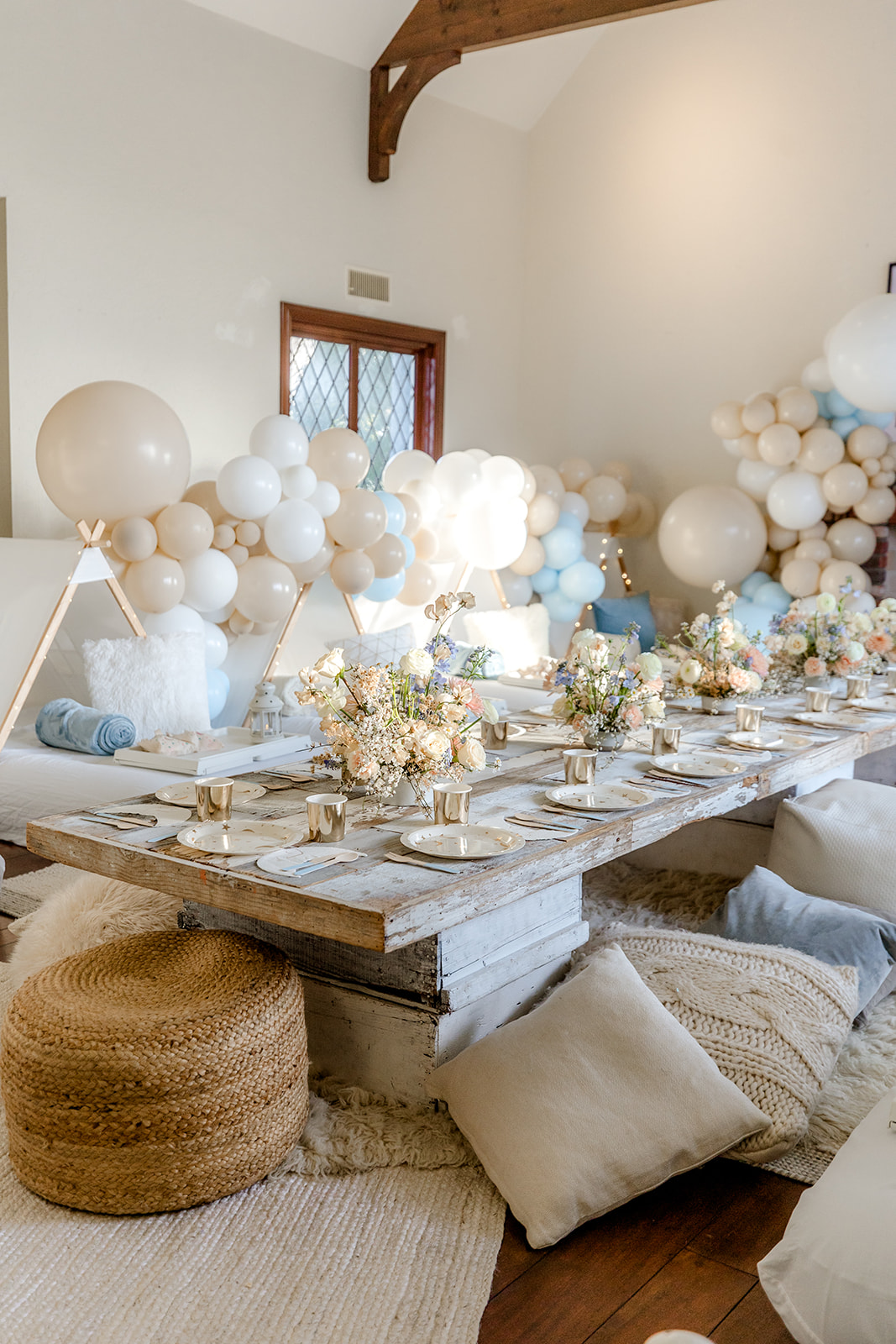 low table with blue and white balloon decorations for girls birthday party