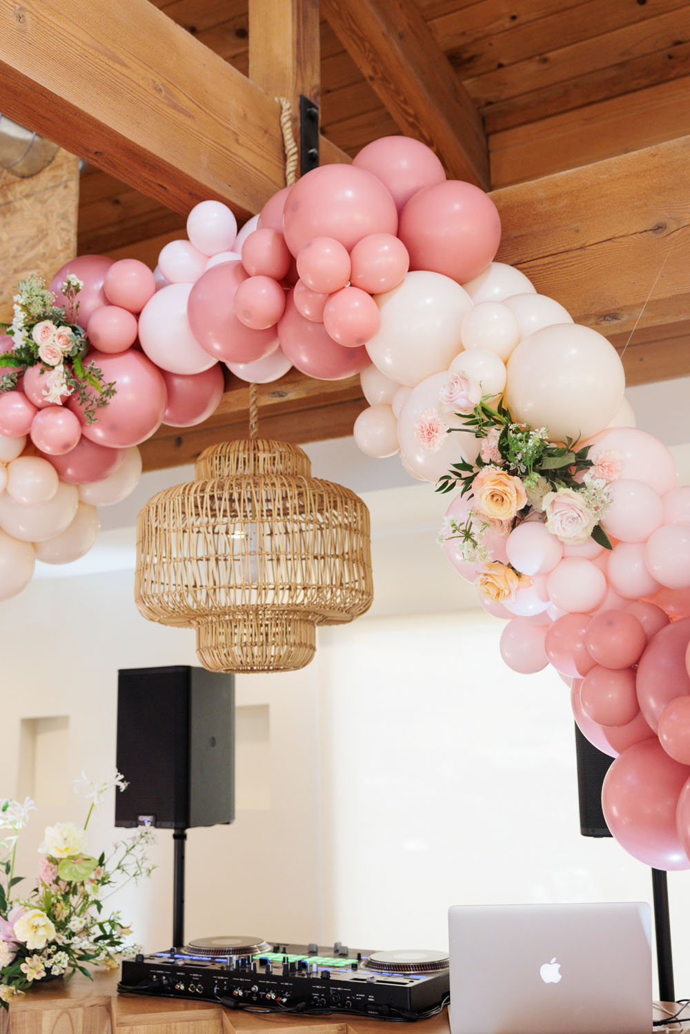 pink balloon arch with flowers