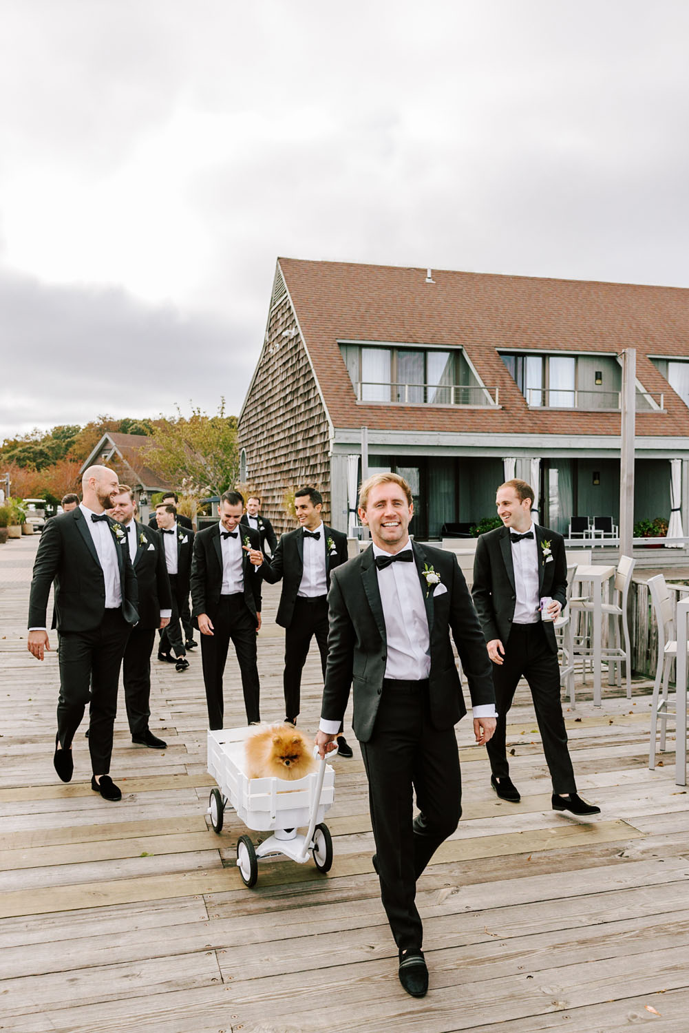 Groom and groomsmen with dog in wedding