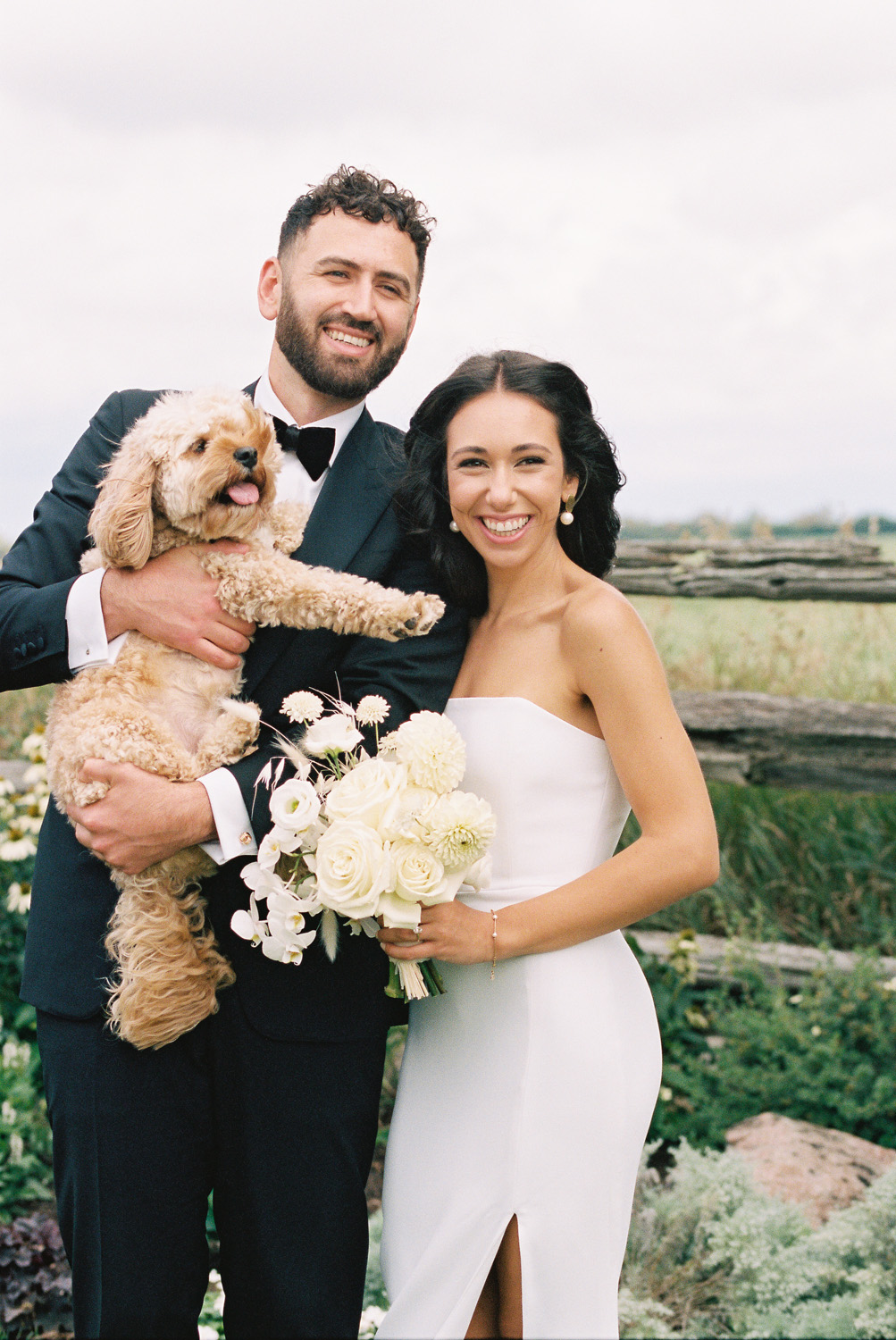 bride and groom with dog at wedding