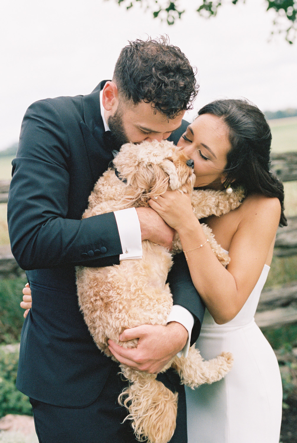 bride and groom with dog at wedding