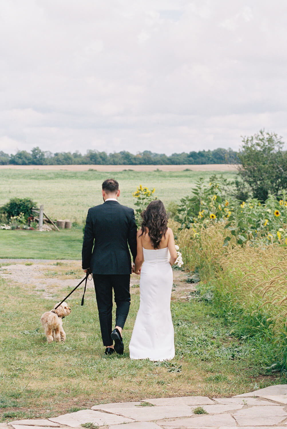 bride and groom with dog at wedding