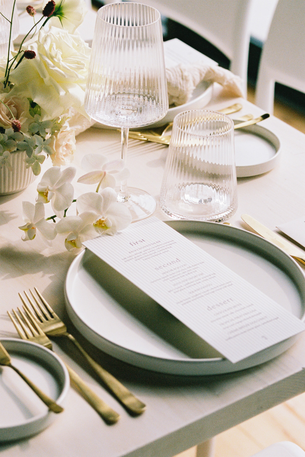 modern all white place setting and menu