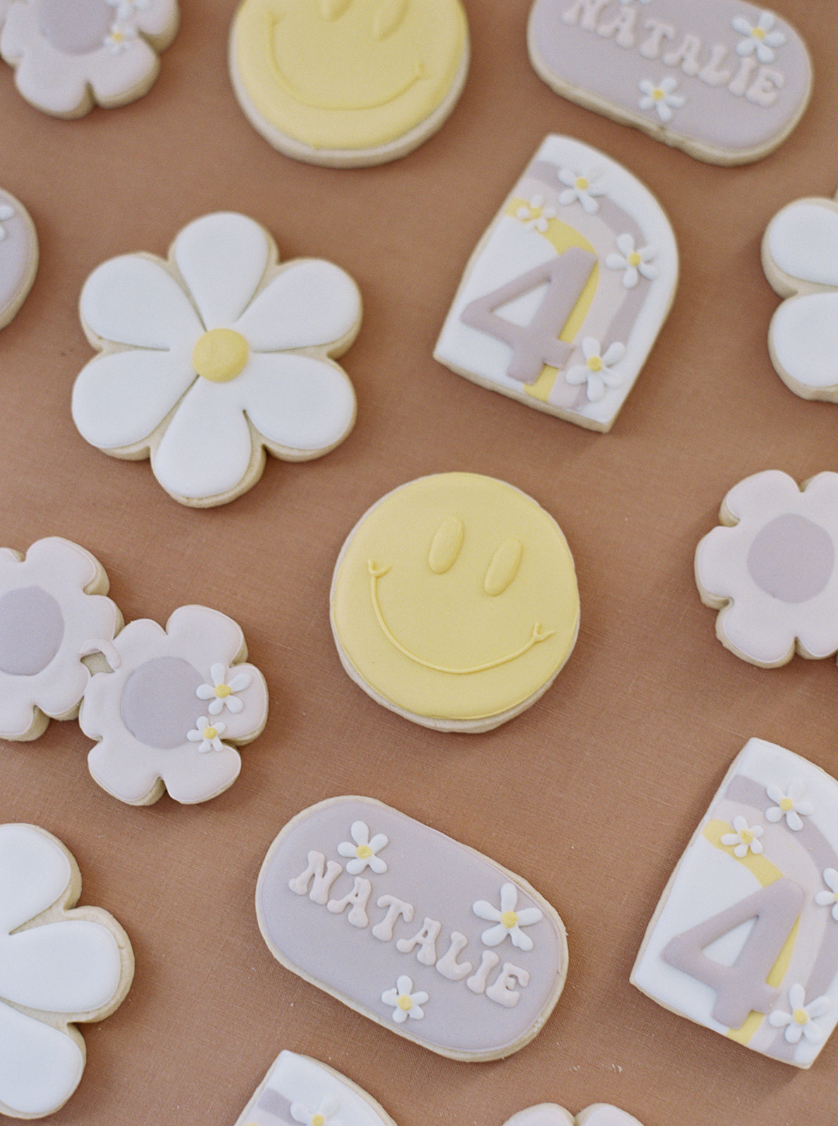 smiley face and daisy themed 4th birthday party cookies