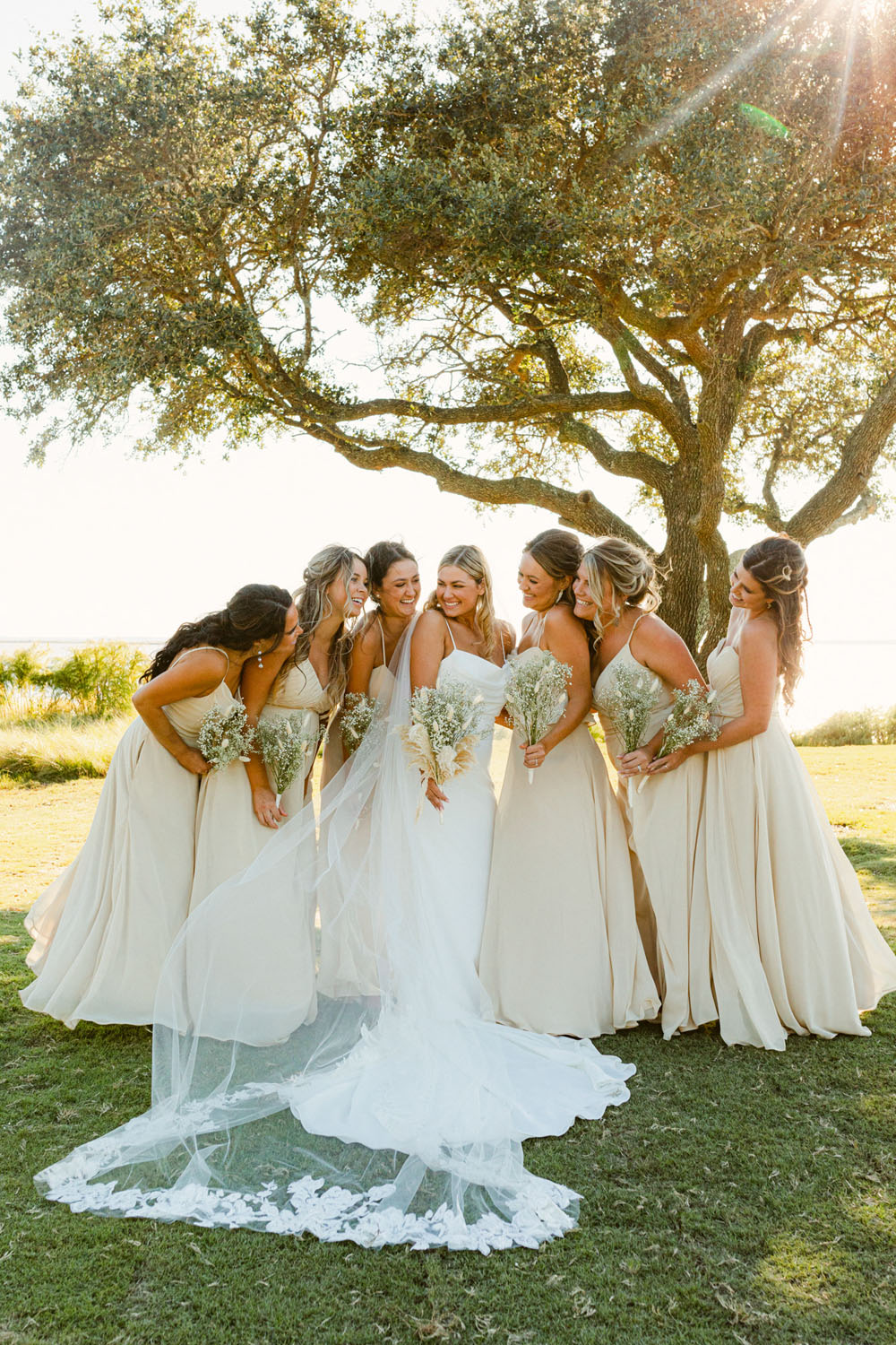 bride with neutral bridesmaid dresses