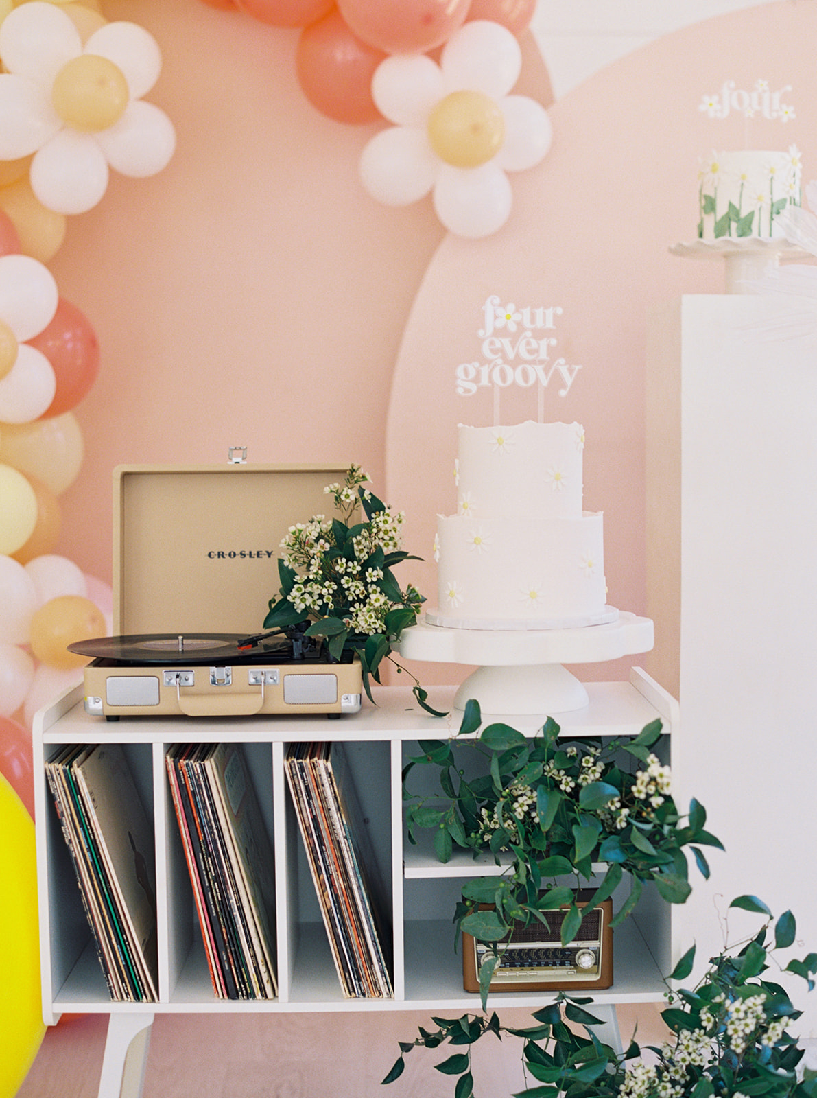 record player and cake table for groovy party theme