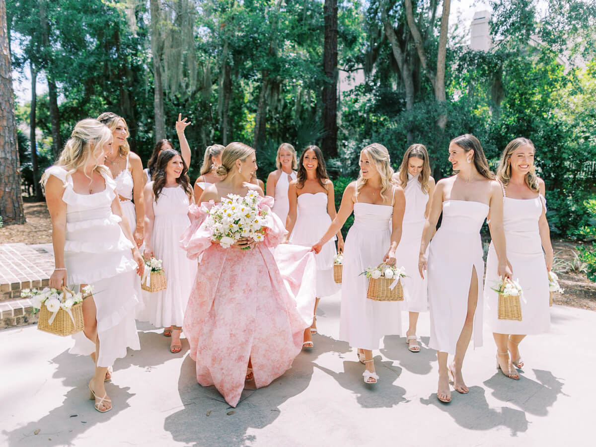 all white bridesmaids with pink wedding dress