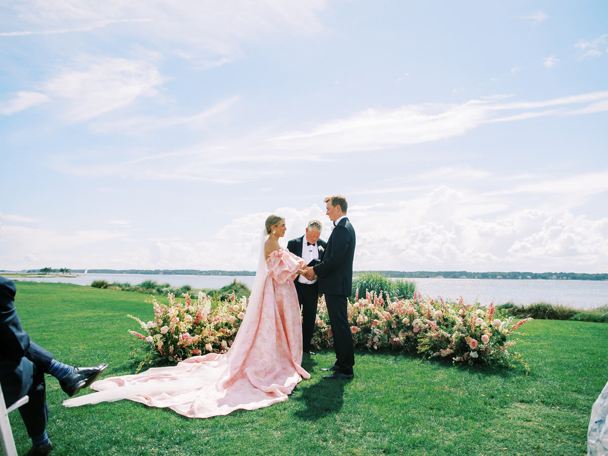 beautiful pink floral wedding ceremony on beach