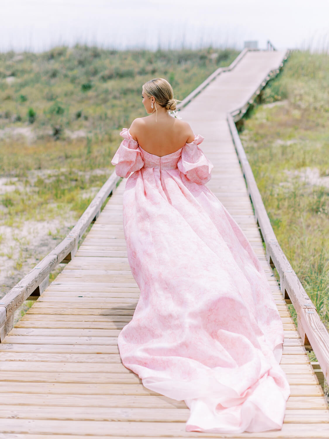bride wearing monique lhuillier petal pink wedding dress