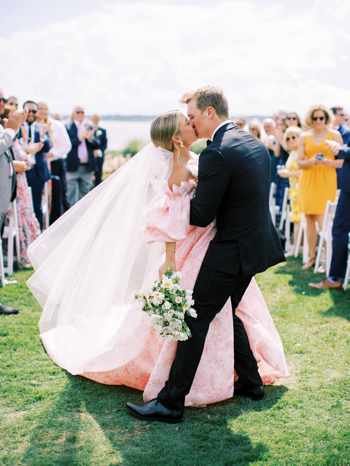 bride and groom kissing at wedding ceremony