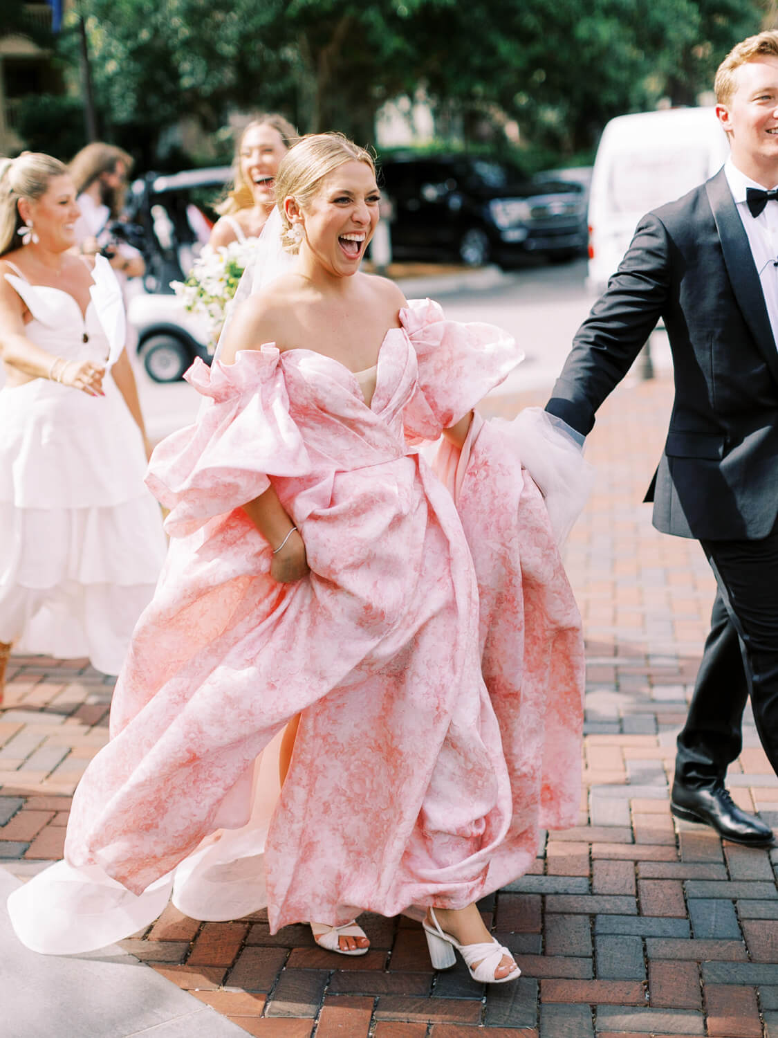 bride wearing monique lhuillier petal pink wedding dress at beachside wedding