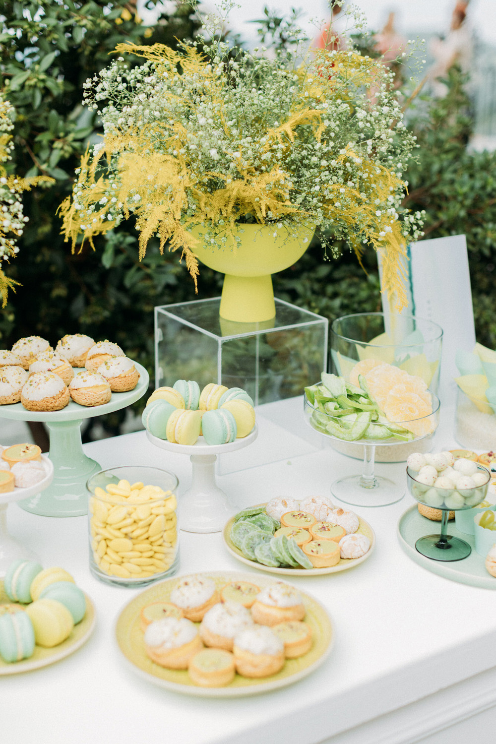 yellow, turquoise and lime green wedding dessert table