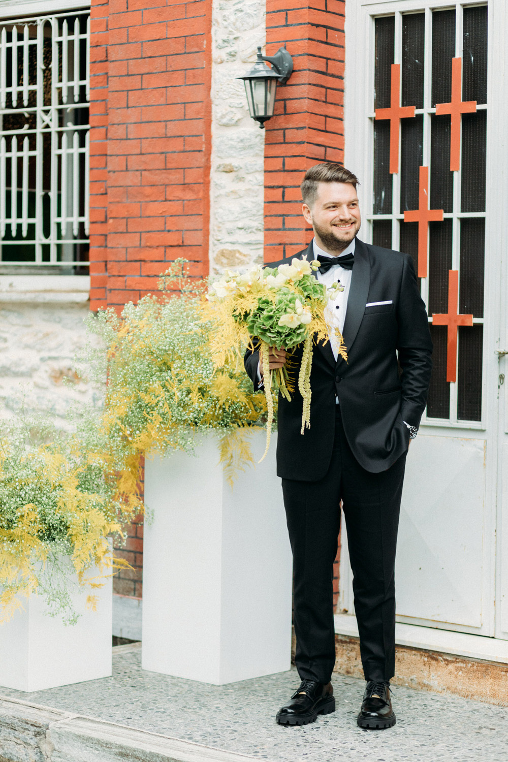 groom with wedding flowers