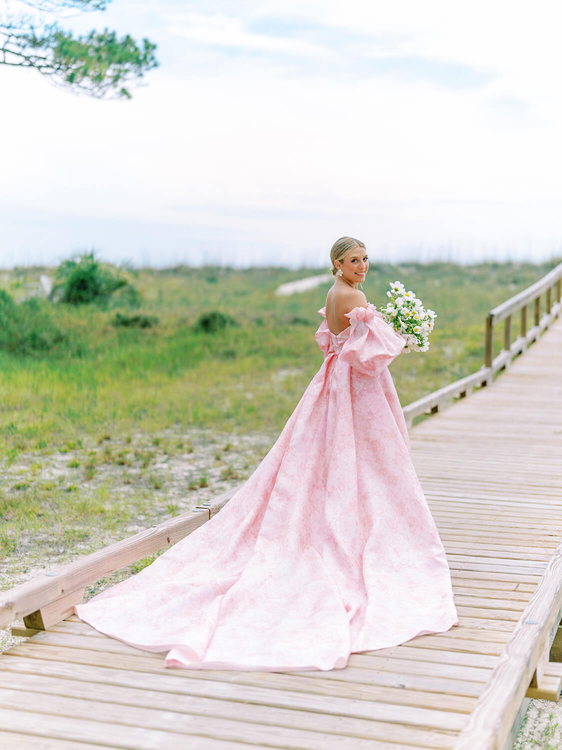 bride wearing monique lhuillier petal pink wedding dress at hilton head wedding