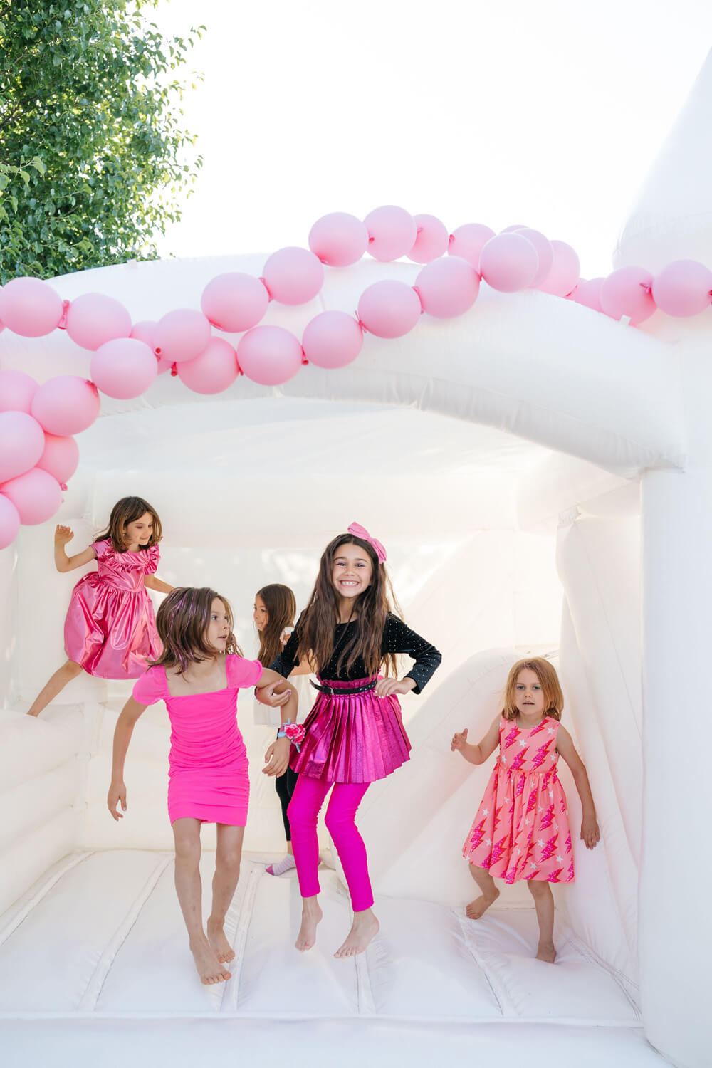 pink and white bounce house for Barbie themed party