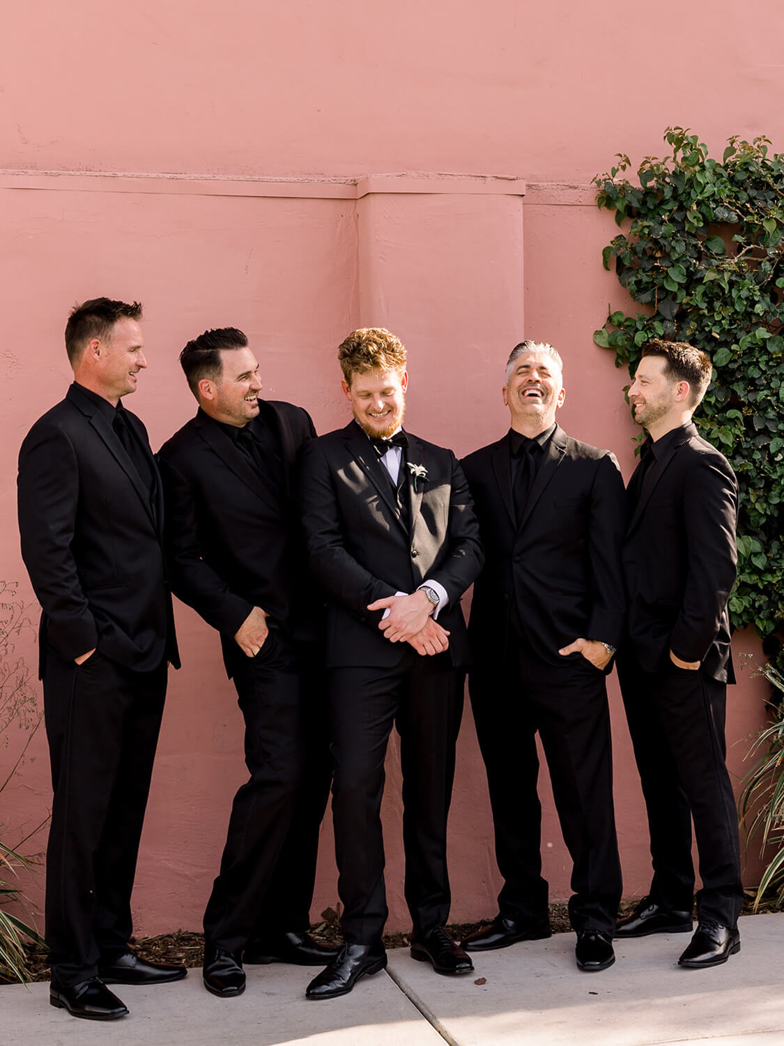 Groom and groomsmen in all black suits