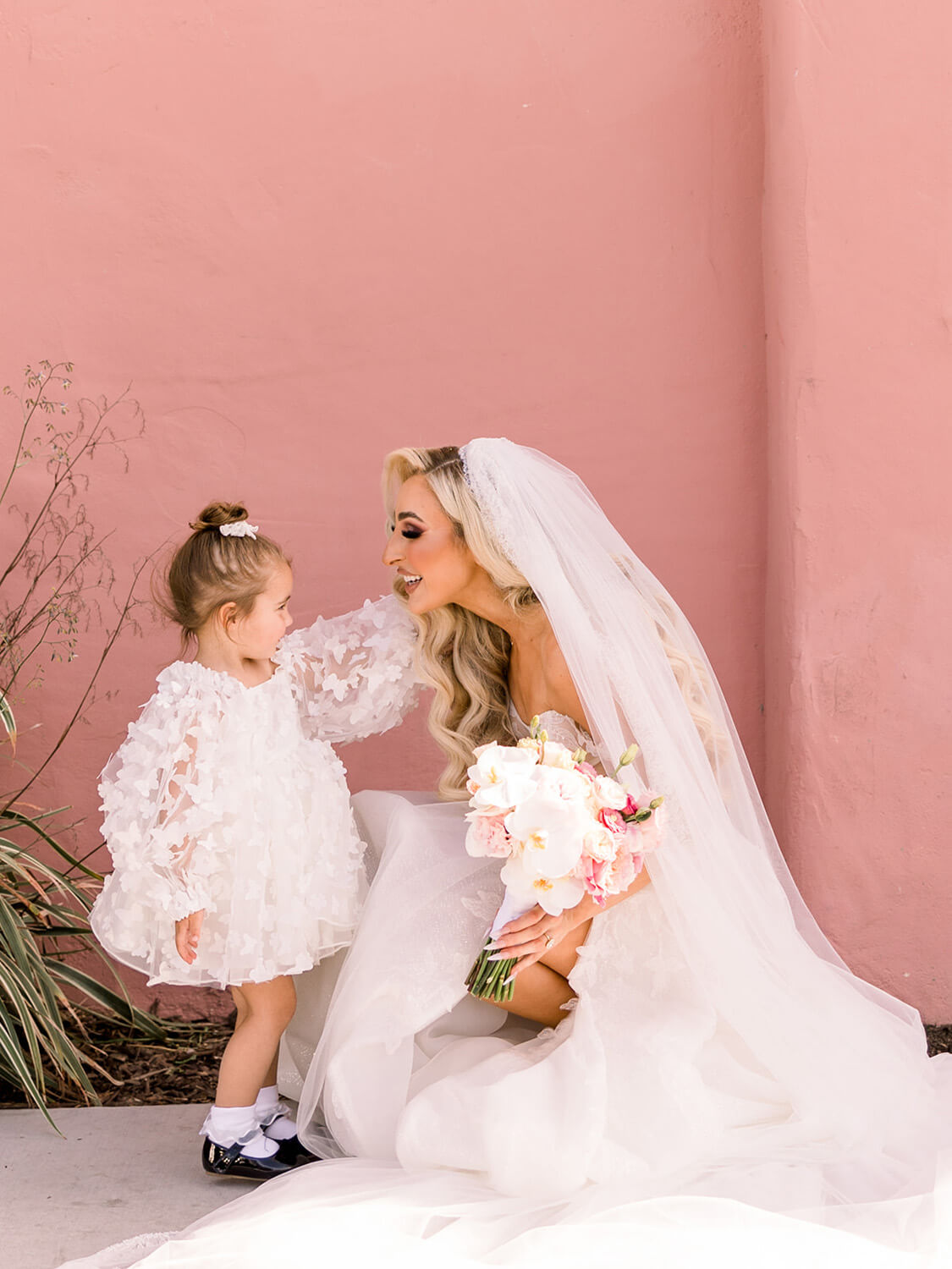 bride with flower girl wearing butterfly dress