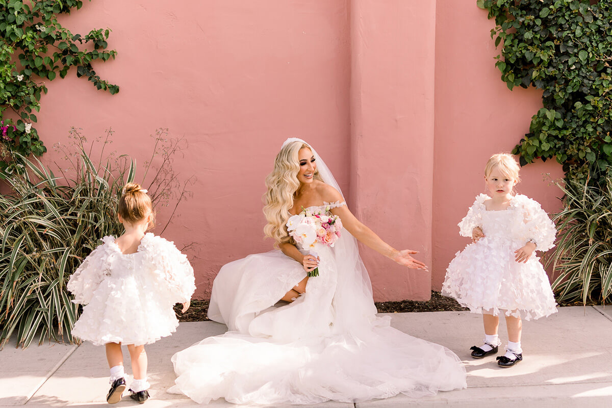 bride with flower girl wearing butterfly dress