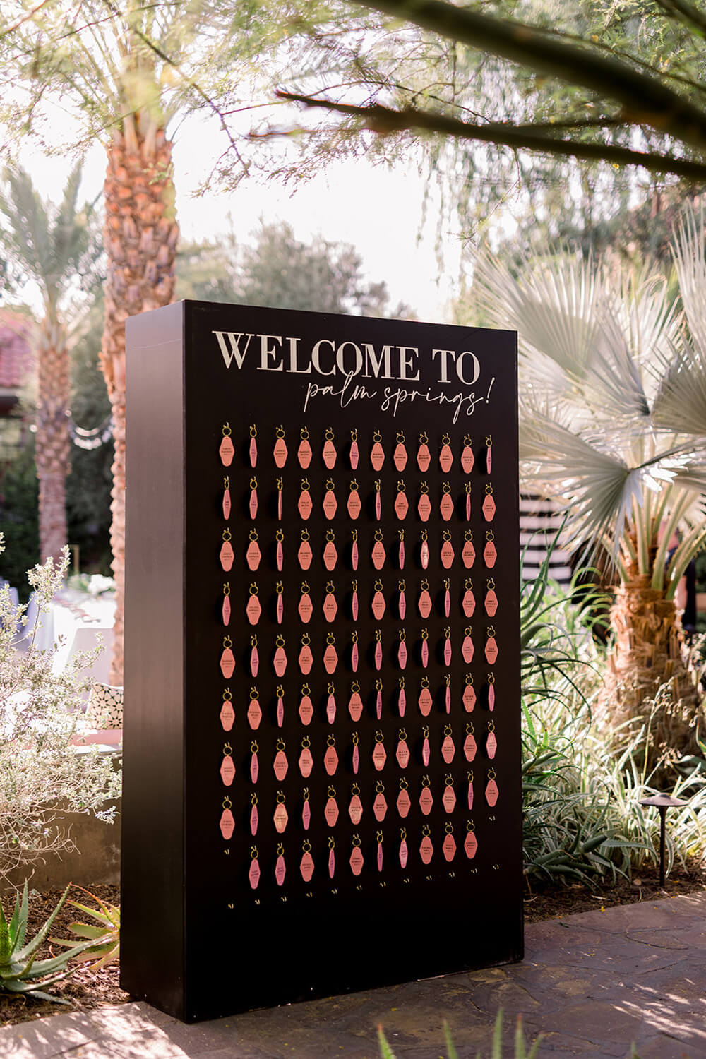 Pink and black escort card wall at Palm Springs weddig