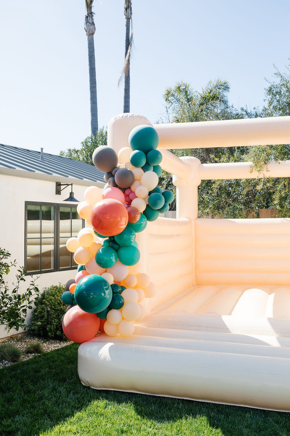 bounce house with big balloons at sister birthday party