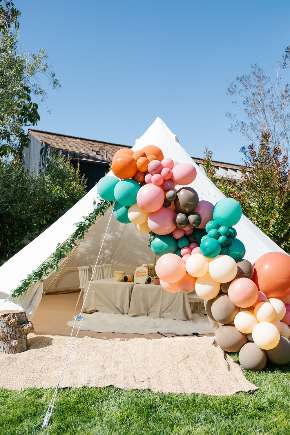glamping tent with balloon decorations for sister birthday party