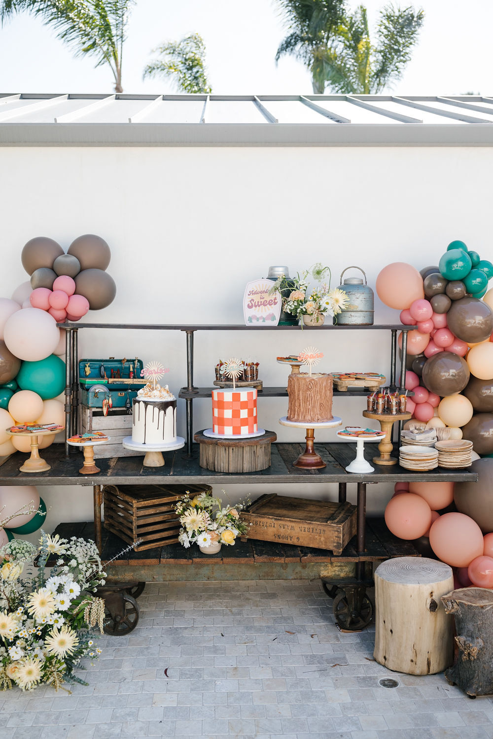 cakes and dessert table with balloon decor for joint sister birthday