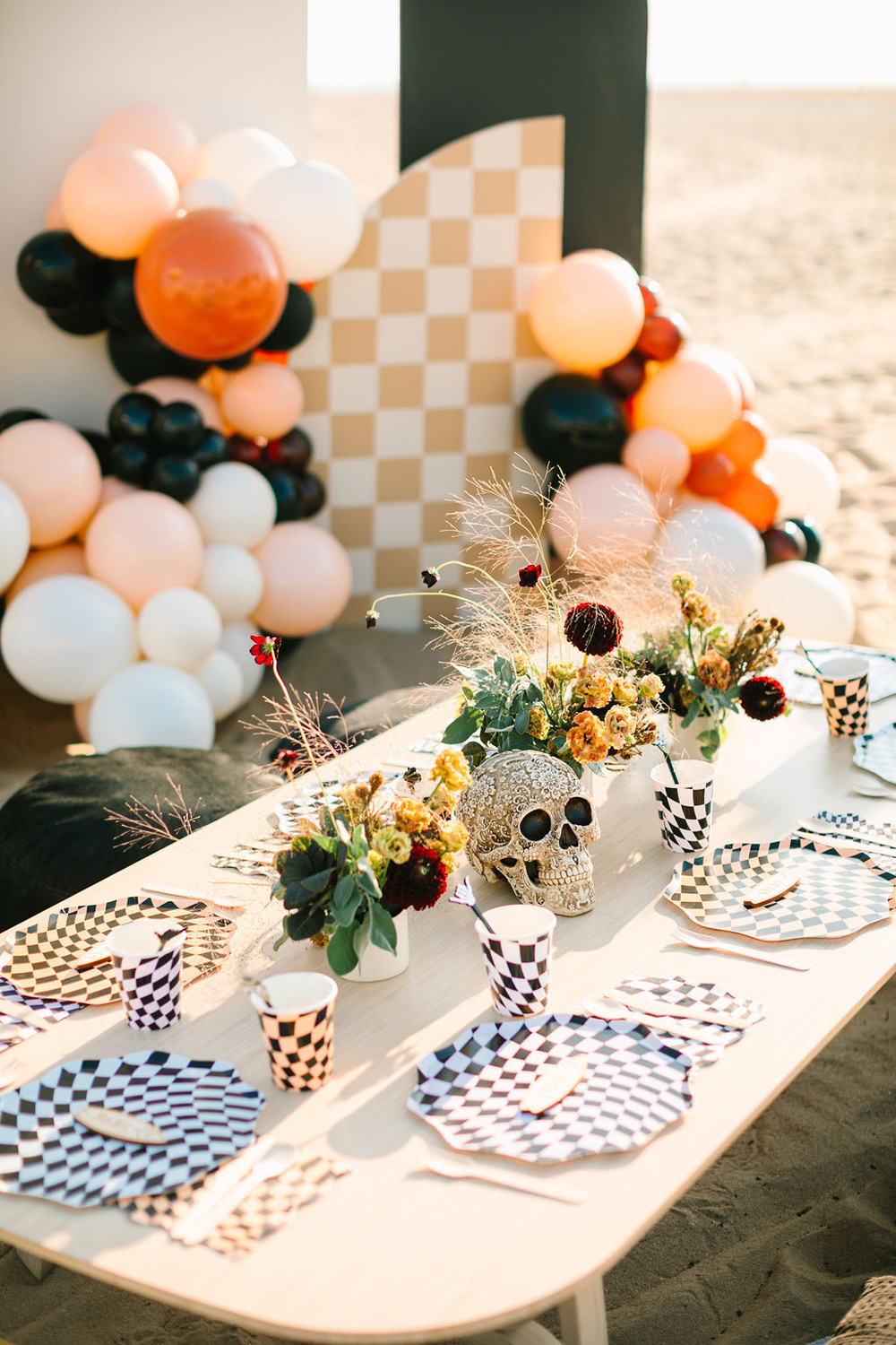 Meri Meri black and white check tabletop decor for "Surf or die" themed halloween party at the beach