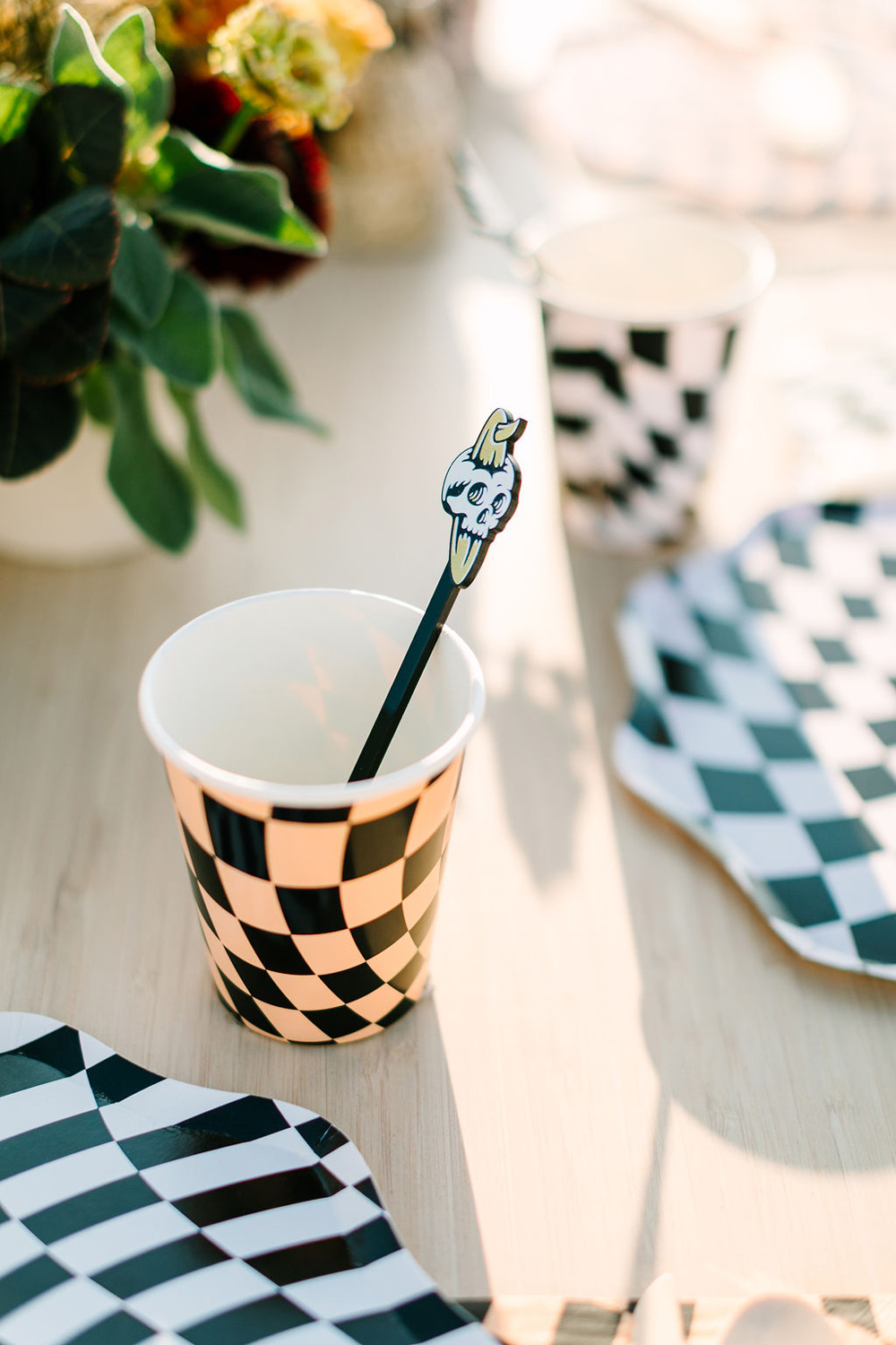 Meri Meri black and white check tabletop decor for "Surf or die" themed halloween party at the beach