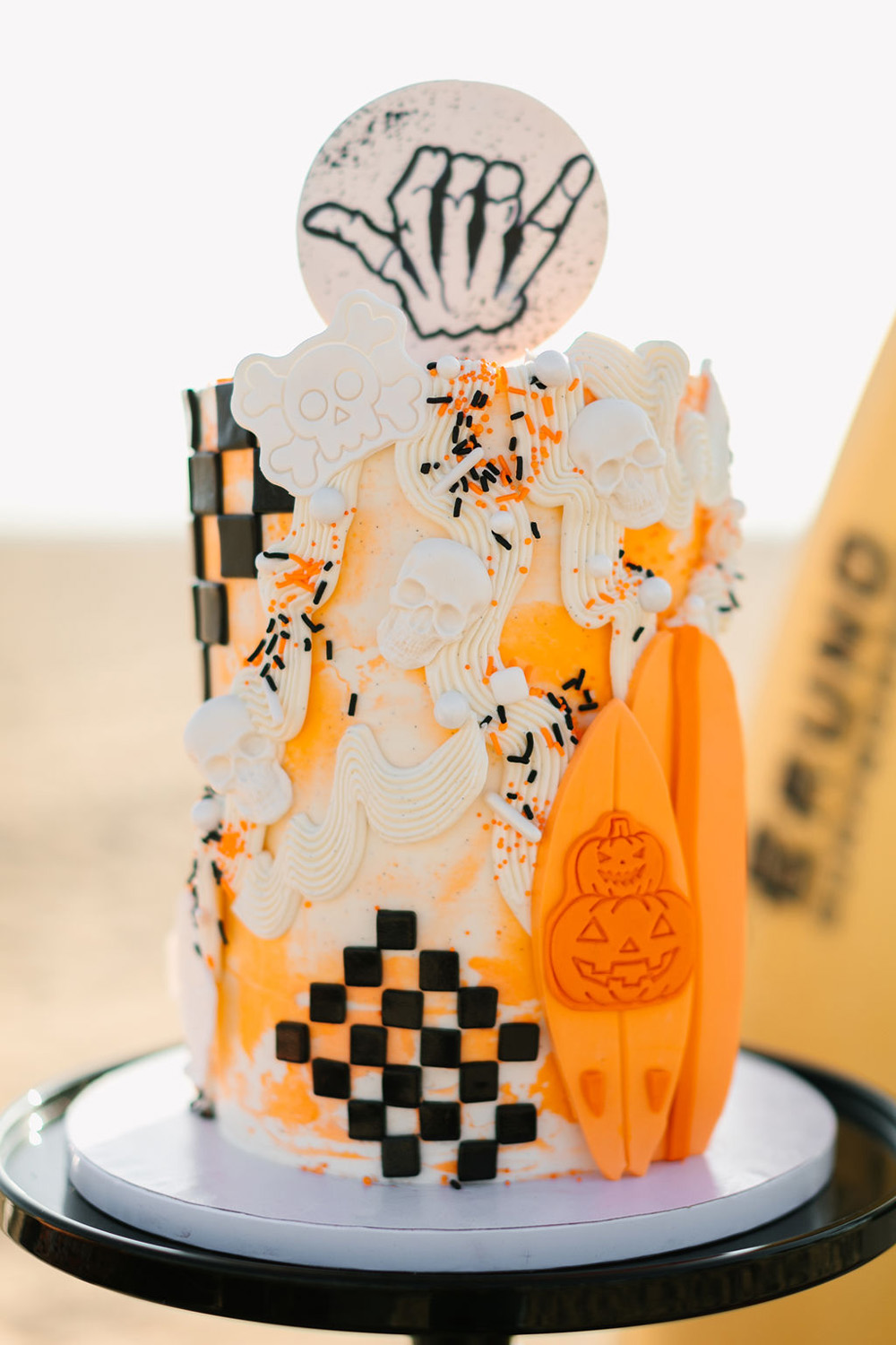 Orange and black Halloween birthday cake for surf themed California beach birthday